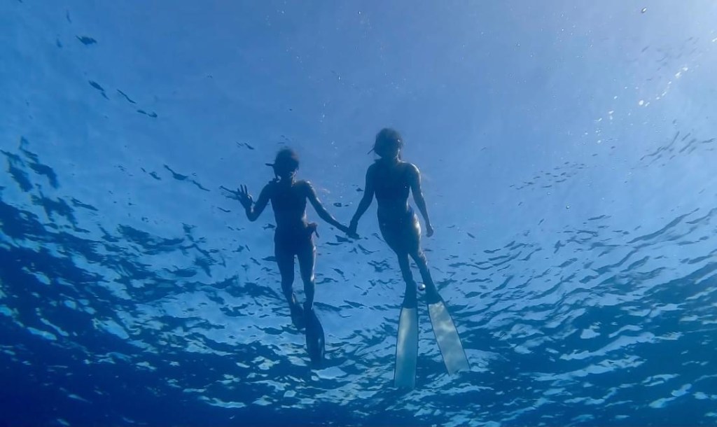 two-girls-freediving-Two-freedivers-practicing-the-buddy-system-for-safe-breath-hold-diving